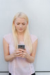 © contrastwerkstatt - Portrait of blonde woman using mobile phone