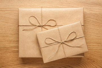 Wall Mural - Two gift boxes wrapped in kraft paper on wooden table