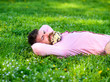 © be free - Man with beard on smiling face enjoy nature. Relaxation concept. Hipster with bouquet of daisies in beard relaxing. Bearded man with daisy flowers in beard lay on meadow, grass background.