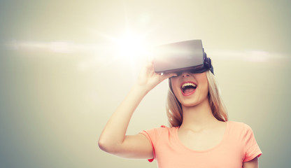 Wall Mural - technology, virtual reality, entertainment and people concept - happy young woman with virtual reality headset or 3d glasses over gray background and laser light