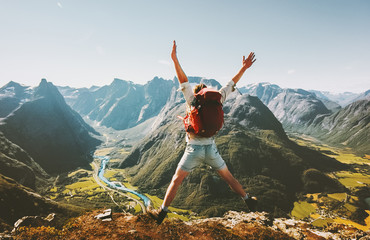 Wall Mural - Happy Man traveler jumping with backpack Travel Lifestyle adventure concept active summer vacations outdoor in Norway mountains success and fun euphoria emotions