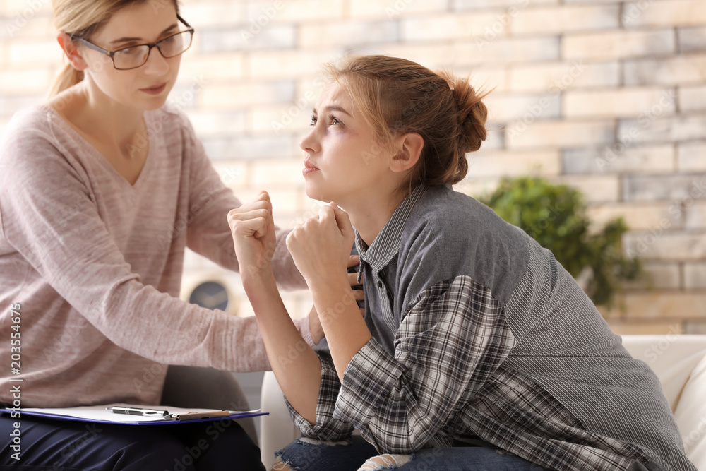 Psychologist working with victim of violence in office