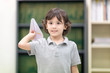 © Nattanon - Happy kids with Paper rocket in hand, Boy explore lifestlye in the Library. Development of Human Resources in Education Concept. Setup studio shooting.