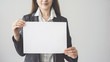 © sebra - Woman holding blank horizontal advertisement card
