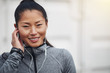 © Flamingo Images - Sporty young Asian woman listening to music before a jog