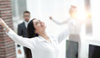 © ASDF - happy young business woman on a blurred office background.