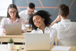 © fizkes - Relaxed smiling african woman enjoying break in coworking, happy millennial black office worker or student feeling no stress free relief at work, afro american intern dreaming of future success in