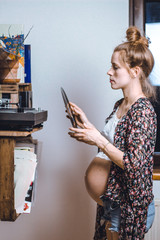 pregnant woman putting a vinyl record on her turntable