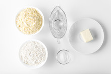 Ingredients For The Preparation Of Mexican Tortilla Corn Tortillas: Wheat Flour, Corn Flour, Butter, Water, Salt On A White Table, Top View