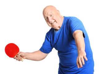 Wall Mural - Senior man playing table tennis against white background