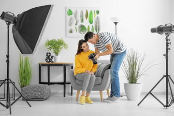 Wall Mural - Photographer and model discussing picture on camera display in professional studio