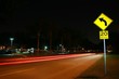 © kthx1138 - Yellow Speed Limit 20 Mph Sign in a Residential Neighborhood at Night with Car Lights Streaking by in a Long Time Exposure
