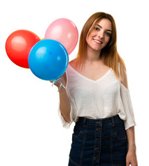 Wall Mural - Happy beautiful young girl holding a balloon