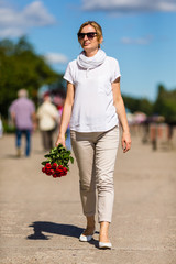 Wall Mural - middle-aged woman walking in city park