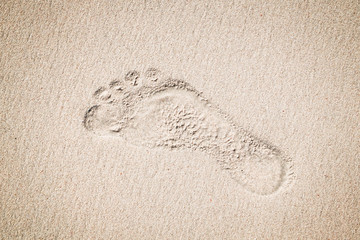 Canvas Print - Lonely trace from a bare foot on sand.