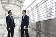 © khwanchai - two business talking with partner about business and invetment  on way to office