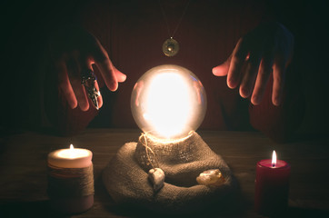 Crystal ball and fortune teller hands. Divination concept. The spiritual seance. Future reading.