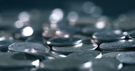 Wall Mural - pan shot of close up money coin stacking on  the floor in dark light , business and financial for money saving or the investment background concept  , extremely close up and shallow DOF