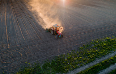 Poster - Tractor working in field in spring