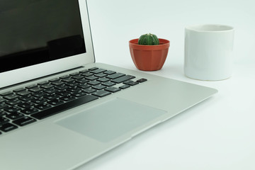 Creative flat lay design of workspace desk with laptop, cactus and coffee.