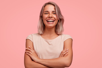 people, happiness and facial expressions concept. pretty young woman with broad shining smile, keeps