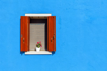 Window on blue wall in Burano, Italy.