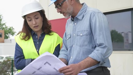 Poster - Construction engineers meeting outside building