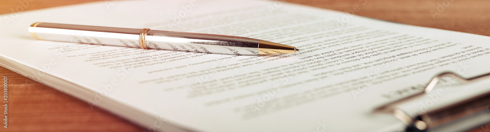 Pen lying on a contract or application form, wide angle view. - obrazy, fototapety, plakaty 