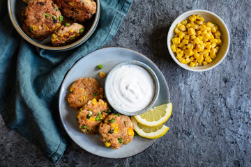 Wall Mural - Tuna Fish cakes with green peas, corn and scallion served with sour cream dip