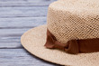 © DenisProduction.com - Straw hat on wooden table, extreme close up. Wooden desk surface background.