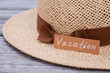 © DenisProduction.com - Straw hat for vacation, close up. Wooden desk surface background.