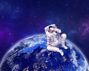 Wall Mural - astronaut sitting on planet earth surface, holding hand on head. elements of this image furnished by