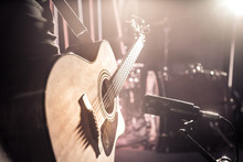 The Studio Microphone Records An Acoustic Guitar Close-up. Beautiful Blurred Background Of Colored Lanterns.