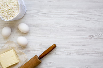 Ingredients for dough preparation on white wooden background, from above. Copy space. Flat lay. Top view.