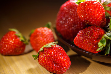 Wall Mural - fortified Breakfast with ripe strawberries, a plate on the table, close-up, beautiful background for the kitchen