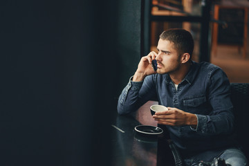 Wall Mural - man using phone inside a restaurant