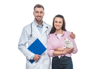 young woman holding little cat in hands and male veterinarian isolated on white background