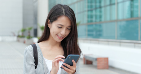 Young Woman use of smart phone in city