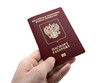 International Russian passport in a male hand on an isolated background