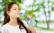 © fotofabrika - Beautiful smiling young woman holding a bottle of water