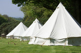 Fototapeta  - Old style double circular canvas tents in field