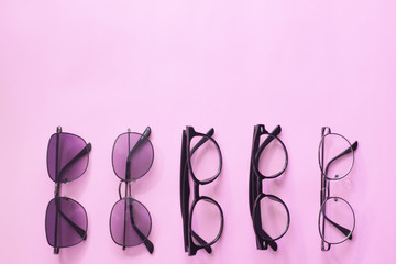 Set glasses or sunglasses object fashion minimal modern style, accessory travel on Pink pastel color background. Top view