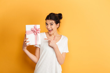 Portrait of an excited young woman holding present box