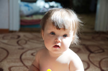 Authentic Portrait Of Baby Girl. Little Child Face Closeup In Natural Light At Home. Caucasian Kid With Blue Eyes