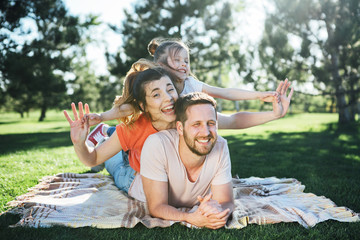 Wall Mural - Happy family rest in park.