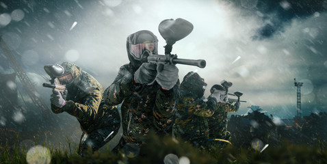 paintball team in uniform and masks, extreme sport