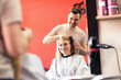© didesign - Smiling hairdresser and customer in hair salon
