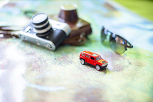Car, Glasses And Camera On The World Map