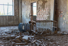 Oil Barrel And A Crate In Abandoned Industrial Building