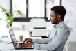 © Syda Productions - business, people and technology concept - african american businessman with laptop computer working at office